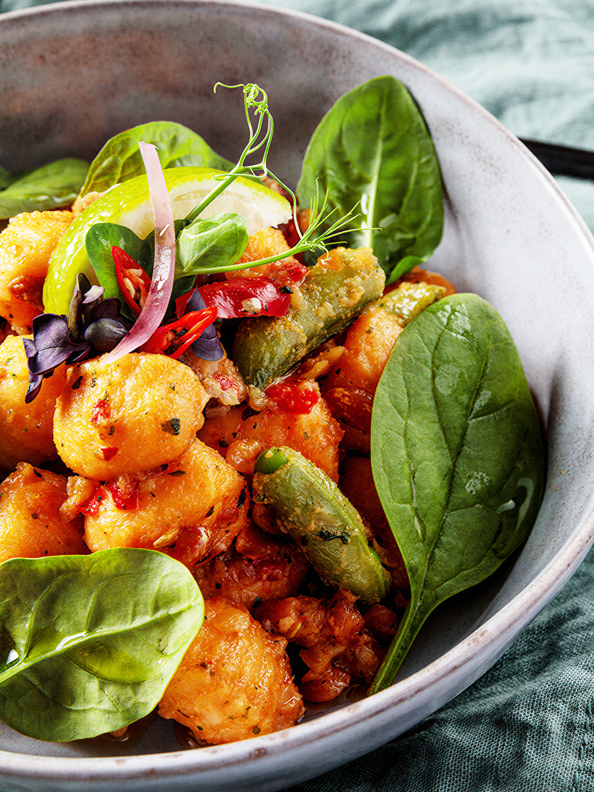 Sweet potato gnocchi in a bowl with baby spinach